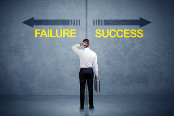 Businessman standing in front of success and failure arrow concept