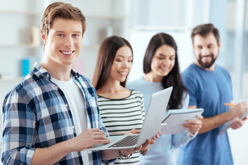 Social factor. Vigorous jolly four colleagues coming up with ideas while performing tasks and man...