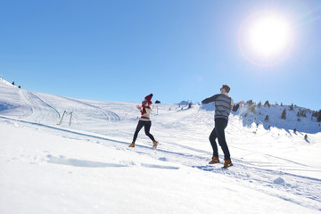 Couple having fun running down slope