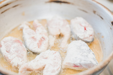 Fish to be pan fried. Slices of fried fish. Fish in flour to be pan fried.