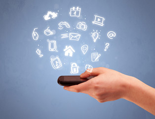 Hand holding tablet phone with drawn icons