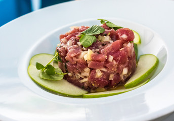 A plate of delicious tuna tartare with green apple