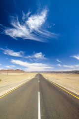 Wide angle view of the C13 road between Noordoewer and Aussenkehr near the South African Border in Namibia, Africa. The road cuts through the Aussenkehr Nature Reserve. Mountains in the background