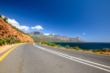 Stunning view of Route 44 near Kogel Bay Beach in the eastern part of False Bay near Cape Town between Gordon`s Bay and Pringle Bay. Hottentots Holland Mountain range in the background.