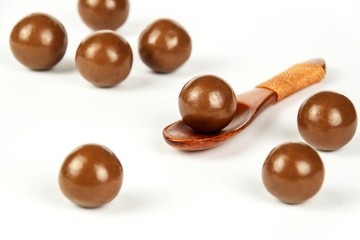 Chocolate balls on the kitchen table. Unhealthy food. Risk of obesity and diabetes.