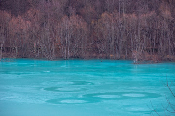 Fototapeta na wymiar Turquoise waste lake contaminated with mining residuals in Geamana