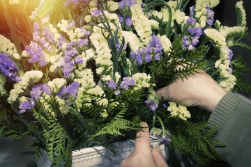 hands working on floral arrangement, florist
