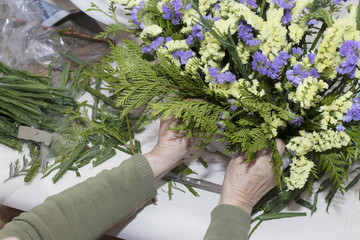 hands working on floral arrangement, florist