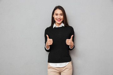 Happy asian business woman in business clothes showing thumbs up