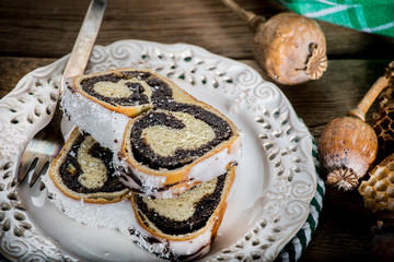 Two pieces of poppie-seed cake on a plate.