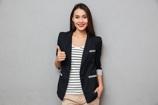Happy asian business woman showing thumb up