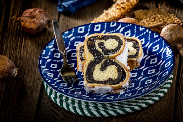 Two pieces of poppie-seed cake on a plate.