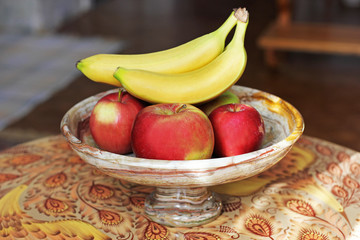 Fruits on a beautiful dish. Marble. bananas and apples.