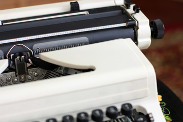 A typewriter, tea and a rose in a vase. Old things. Card