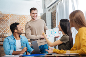 Enthusiastic students. Smart positive young people feeling glad while looking at their fellow...