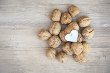 Heart shaped nutcracker on walnuts. Healthy eating concetp. Walnuts are good fot your heart.