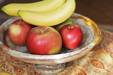 Fruits on a beautiful dish. Marble. bananas and apples.
