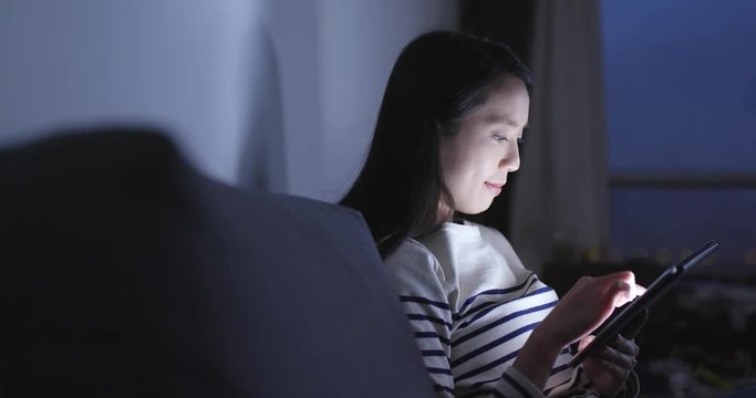 Woman looking at tablet computer at home
