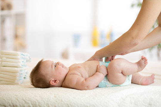 Mother Changing The Baby's Nappy