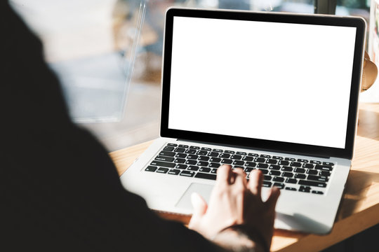 Man using laptop with blank screen at table in the office