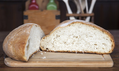 Close up view of an open large loaf of bread in arustic kitchen