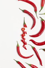Sliced red chili pepper arranged on a plain background
