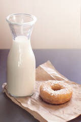 Bottle of milk and doughnut in vintage retro style.