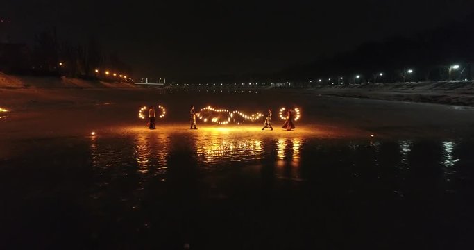 Aerial view of Fire Theater on the ice on frozen river