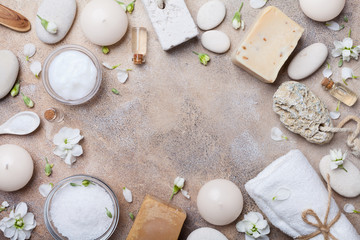 Spa and beauty threatment products background decorated flowers top view. Relax and health concept.
