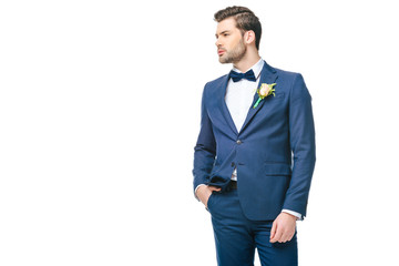 portrait of young handsome groom in suit isolated on white