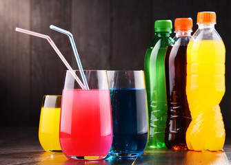 Glasses and bottles of assorted carbonated soft drinks