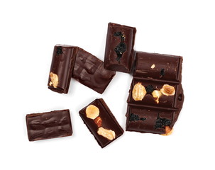 Chocolate bars with blueberries, almonds and hazelnuts isolated on white background, top view