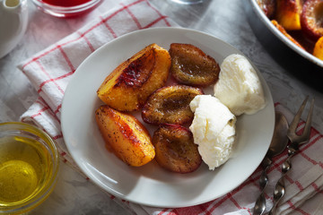 Baked plums and peaches with icecream and cinnamon