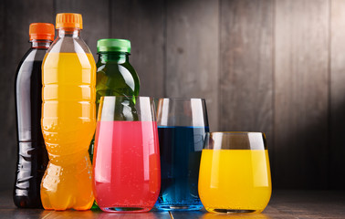 Glasses and bottles of assorted carbonated soft drinks