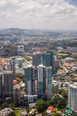 Fototapeta na wymiar Urban views of Kuala Lumpur with tall skyscrapers, drowning in the greenery of parks