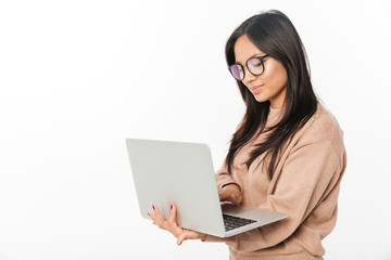 Asian smiling woman wearing glasses using laptop