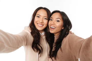 Two asian happy positive ladies sisters