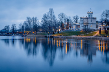 Manor house in front of the lake during twilight blue hour in Druskininkai, Lithuania