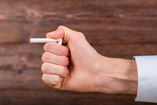Man breaks a cigarette in his hand. Quitting smoking. Concept.