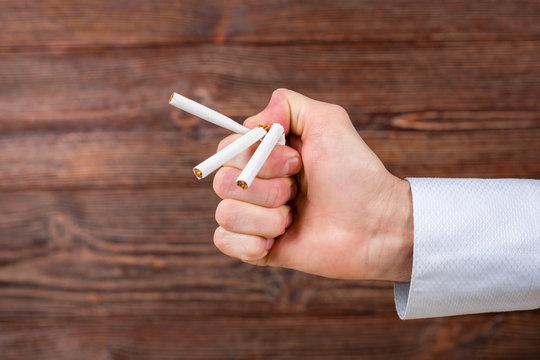 Man breaks a cigarettes in his hand. Quitting smoking. Concept.