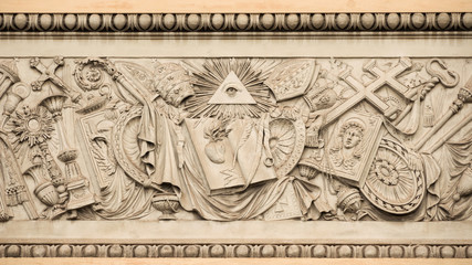 Christian religious symbols with the eye of providence on a 19th century relief in Rome People's...