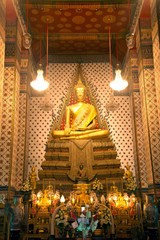 Golden sitting Main Buddha at main Prang of Wat Arun Ratchawararam temple ,Bangkok,Thailand.