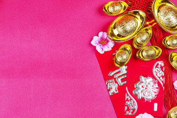 Chinese new year festival decorations, ang pow or red packet and gold ingots. Chinese characters...