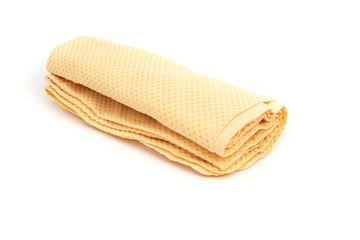 rolled of yellow chamois (microfiber towel) for cleaning concept on white background
