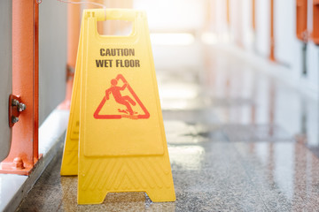 Sign showing warning of caution wet floor at airport