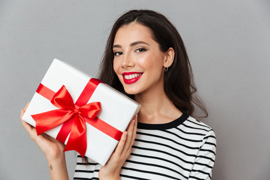 Close up portrait of a happy woman holding gift box
