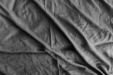 Top view of a messy bedding sheet after night sleep.black and white.