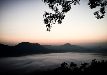 Early morning foggy sunrise on top of mountain soft focus.