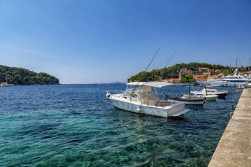 Naklejka na ściany i meble Boats in the crystal clear waters of Cavtat in Croatia.