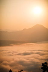 Early morning foggy sunrise on top of mountain soft focus.